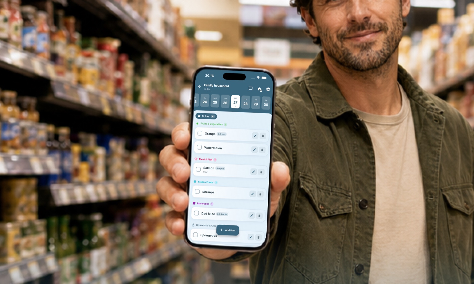 Shopper in a grocery store holding a phone with the Cartly+ shared list